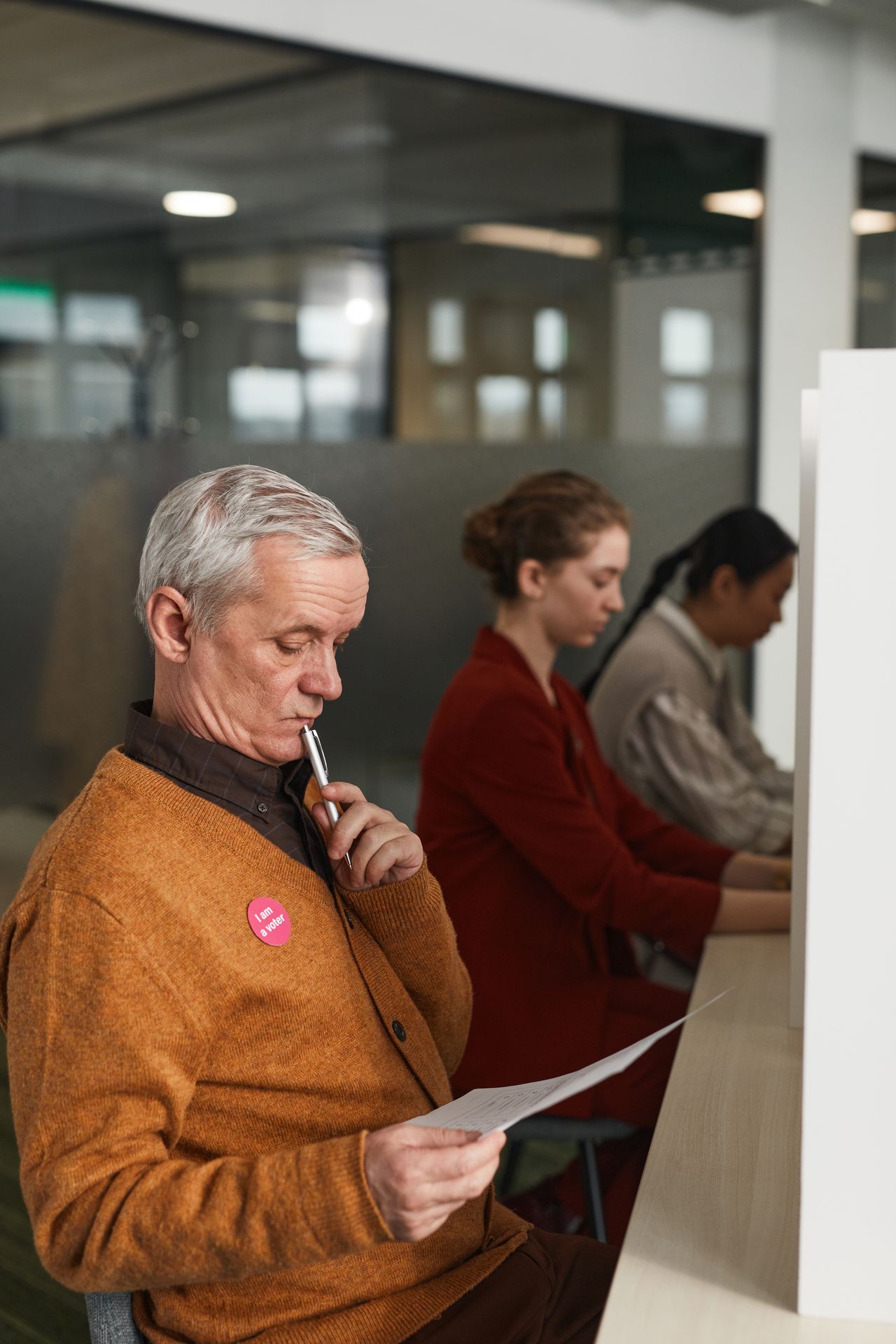 Un votante lee la boleta antes de emitir su voto